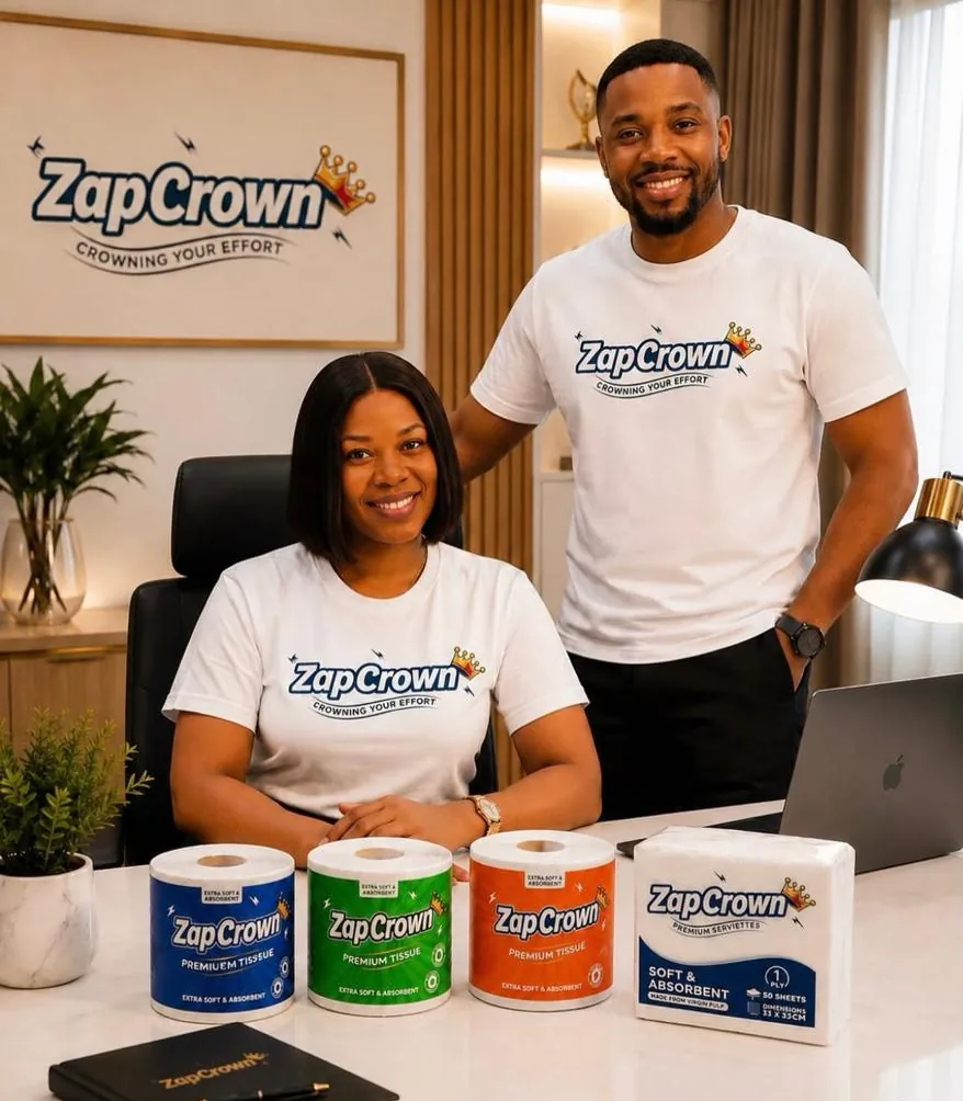 Two members of the team in ZapCrown shirts at a desk with the full ZapCrown product range